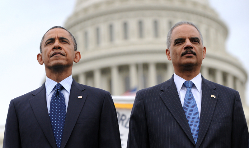 Attorney General Eric Holder (right) and President Barack Obama attend the 32nd annual National Peace Officers’ Memorial Service on the grounds of the U.S. Capitol on May 15, 2013, in Washington, D.C.Olivier Douliery-Pool/Getty Images